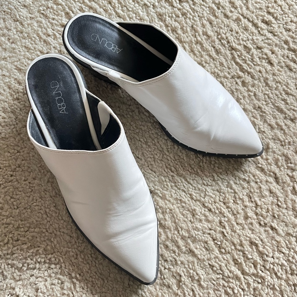Abound white pointed and studded slip ons.